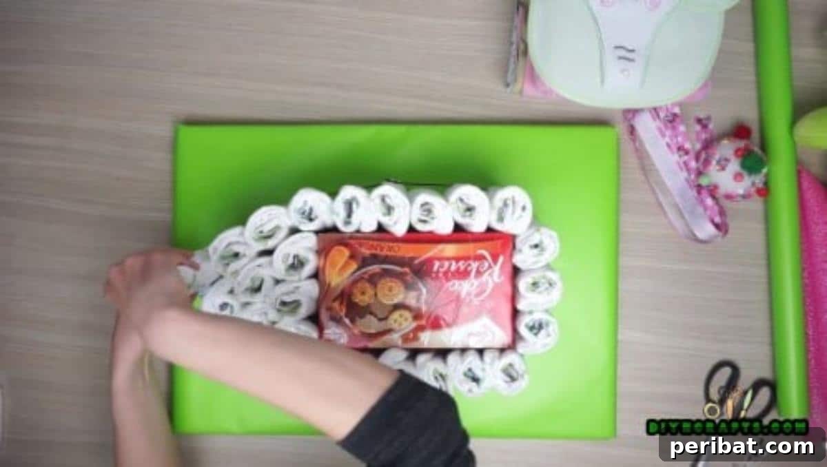 Add more rolled diapers on top of the base layer to build up the boat's deck and shape.
