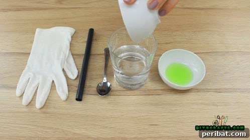 Glycerin being poured into a glass of distilled water, ready for mixing.