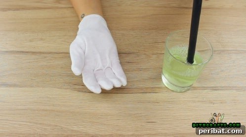 A hand putting on a rubber glove, preparing for the bouncing bubble activity.