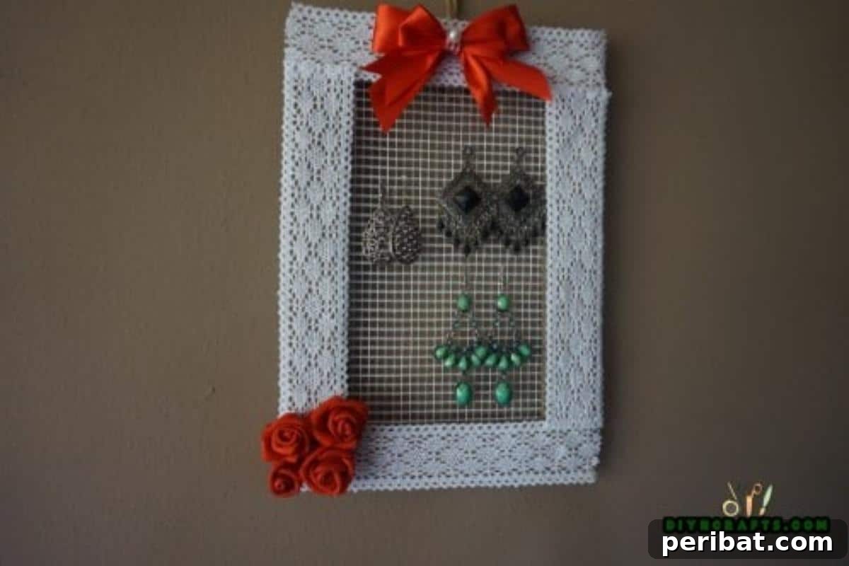 Craft Your Own Stylish Hanging Jewelry Organizer 17 Finished decorative hanging DIY jewelry organizer displayed with jewelry