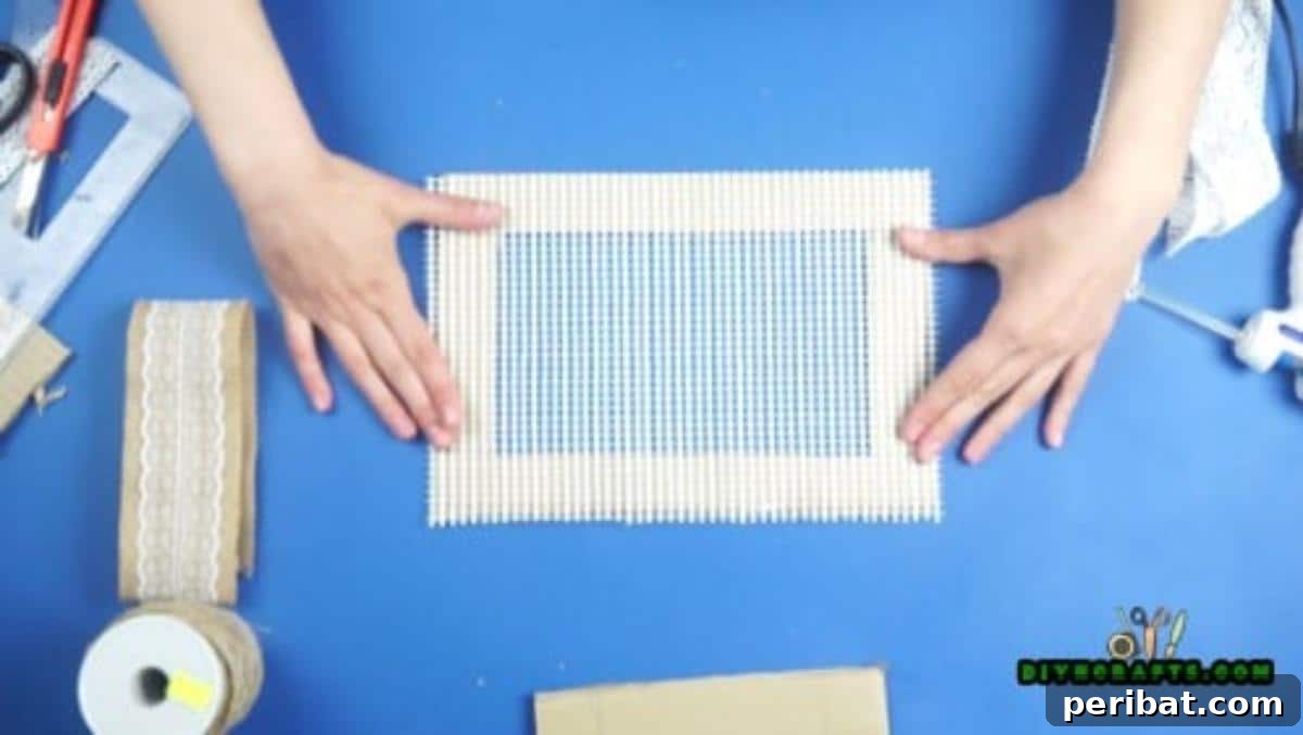 Craft Your Own Stylish Hanging Jewelry Organizer 10 Applying glue to cardboard frame for mesh, Step 3