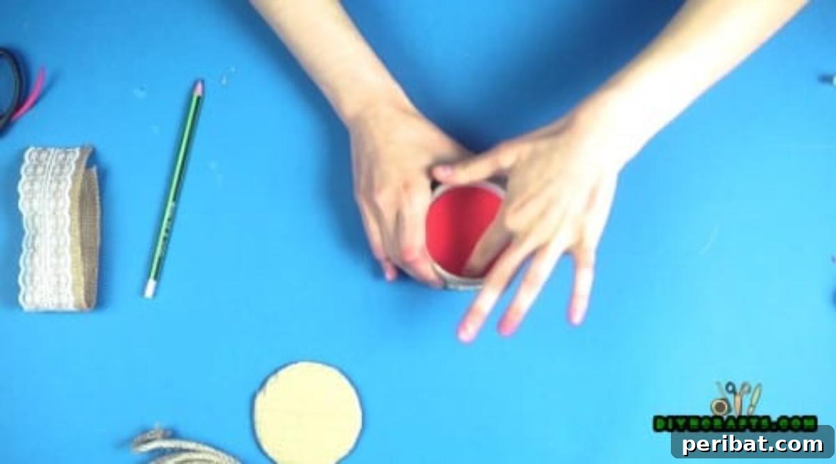 Inserting and gluing a decorative paper circle onto the bottom interior of the duct tape roll.