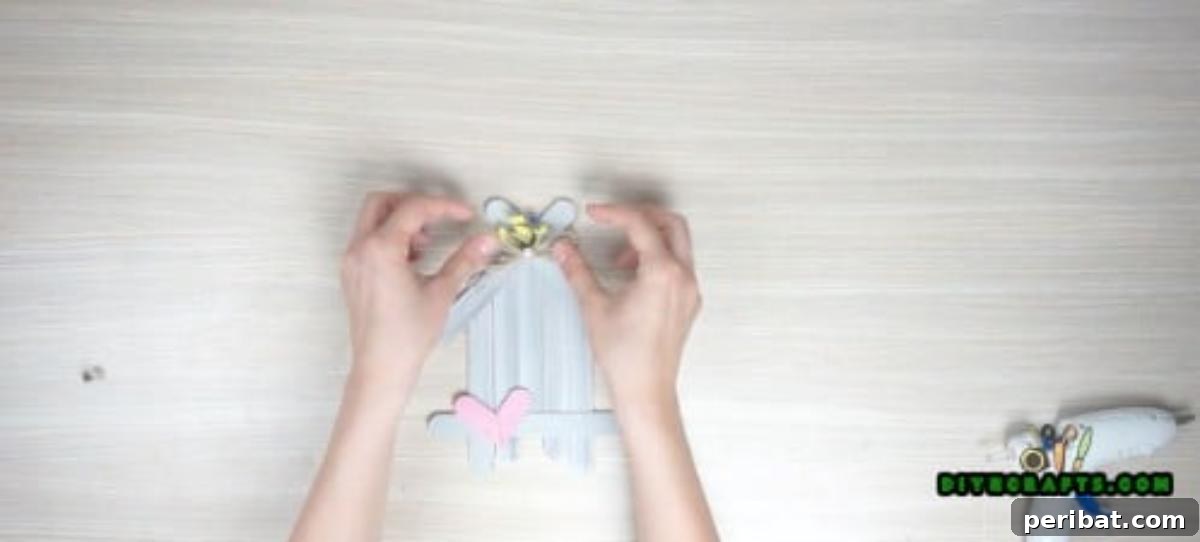 Transform Popsicle Sticks into Adorable Coasters 11 Final touches of embellishments on the charming DIY house coaster.