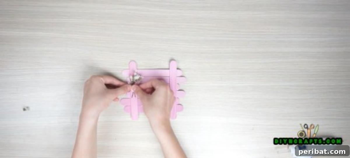 Transform Popsicle Sticks into Adorable Coasters 5 Attaching embellishments to the finished DIY square coaster.