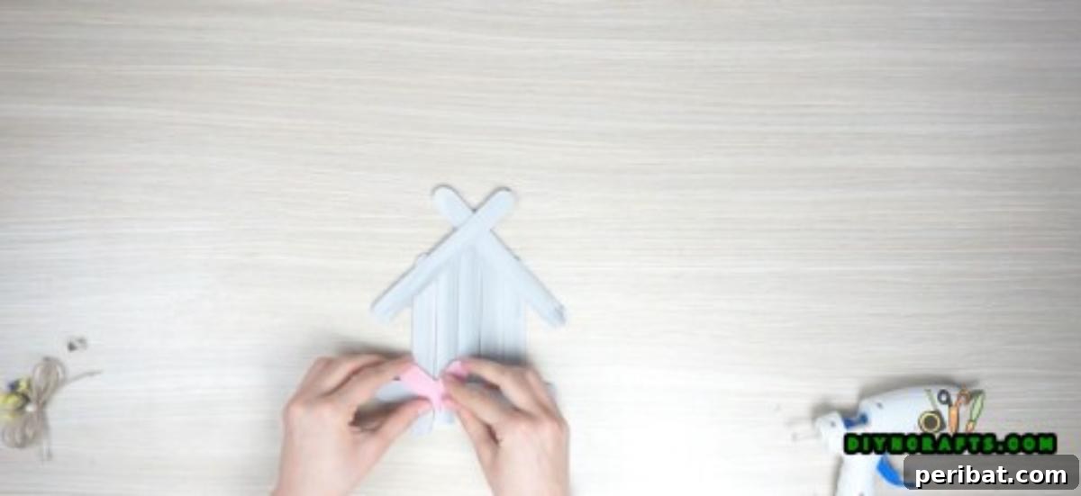 Transform Popsicle Sticks into Adorable Coasters 10 Adding creative embellishments to personalize the house-shaped coaster.