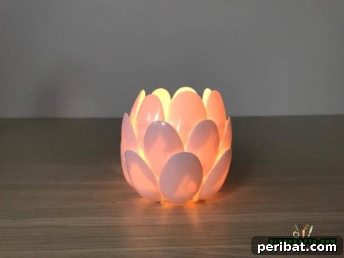 DIY Beautiful Candle Holders From Simple Materials 11 Completed plastic spoon candle holder, resembling a delicate flower blossom, showcasing the layered petals.