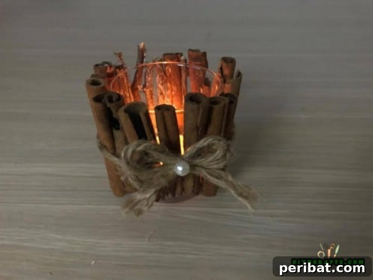 DIY Beautiful Candle Holders From Simple Materials 6 Completed cinnamon stick votive candle holder with twine and rustic embellishments, ready to display.