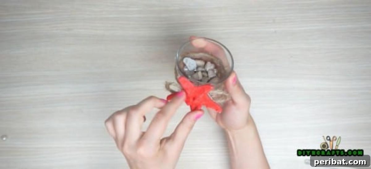 Preparing to insert a votive candle into the decorated holder.