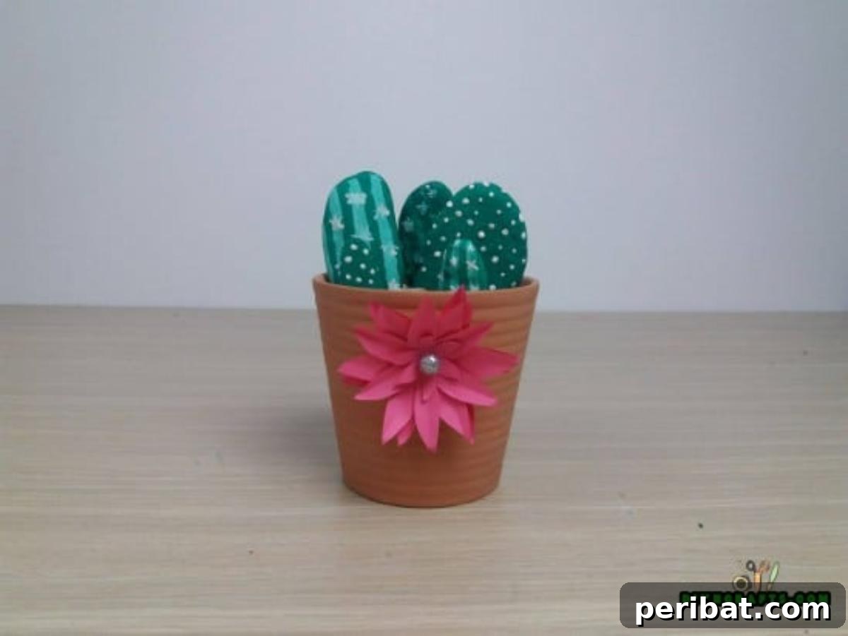 The complete adorable faux stone cactus garden in a decorated flower pot.