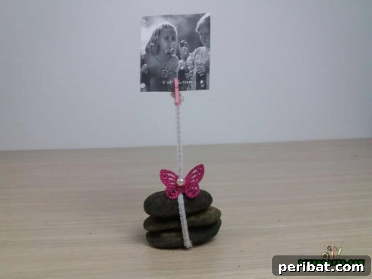 Detailed view of the charming DIY river stone photo holder with a clip.