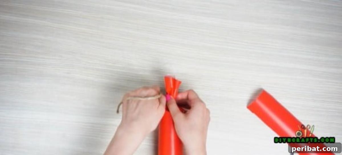 Scrunched ends of a paper roll candy secured with twine, showcasing the unique decorative touch.