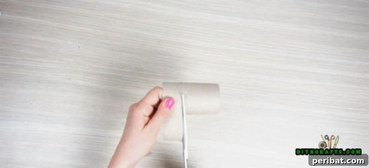 Cutting a paper roll to a smaller size, perfect for making a DIY napkin ring.