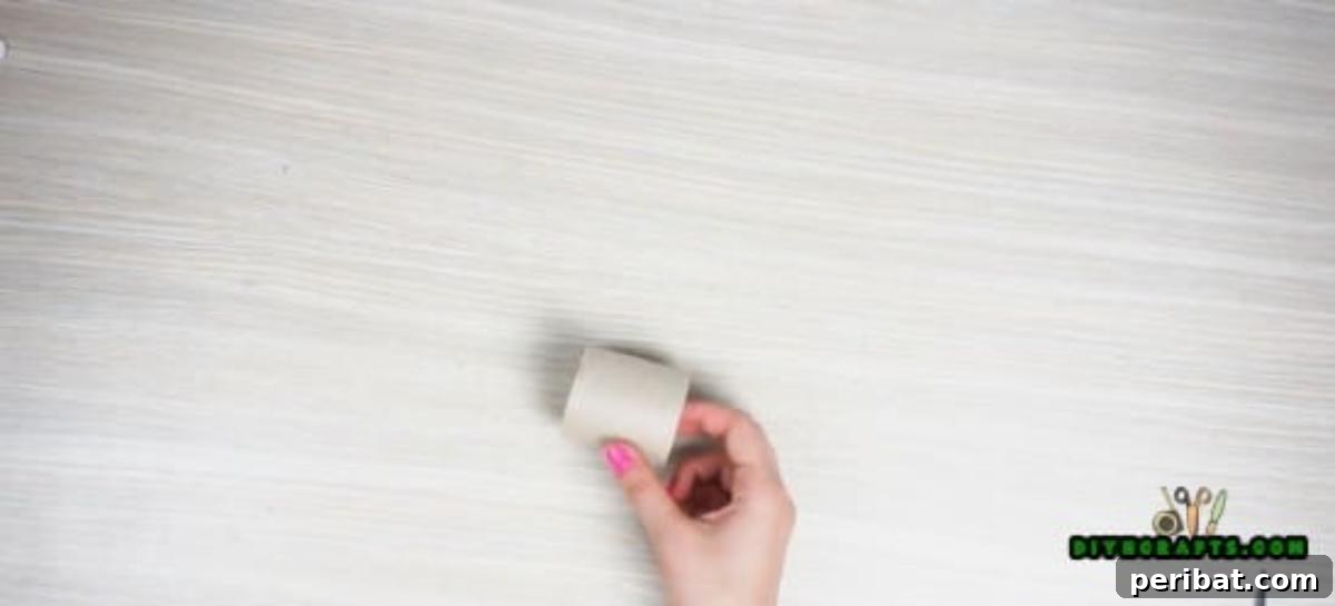 Close-up of a neatly cut paper roll segment, sized to become a base for a napkin ring.