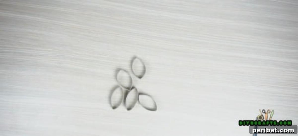 Collection of thin paper roll slices, prepared as petals for the flower candle holder project.