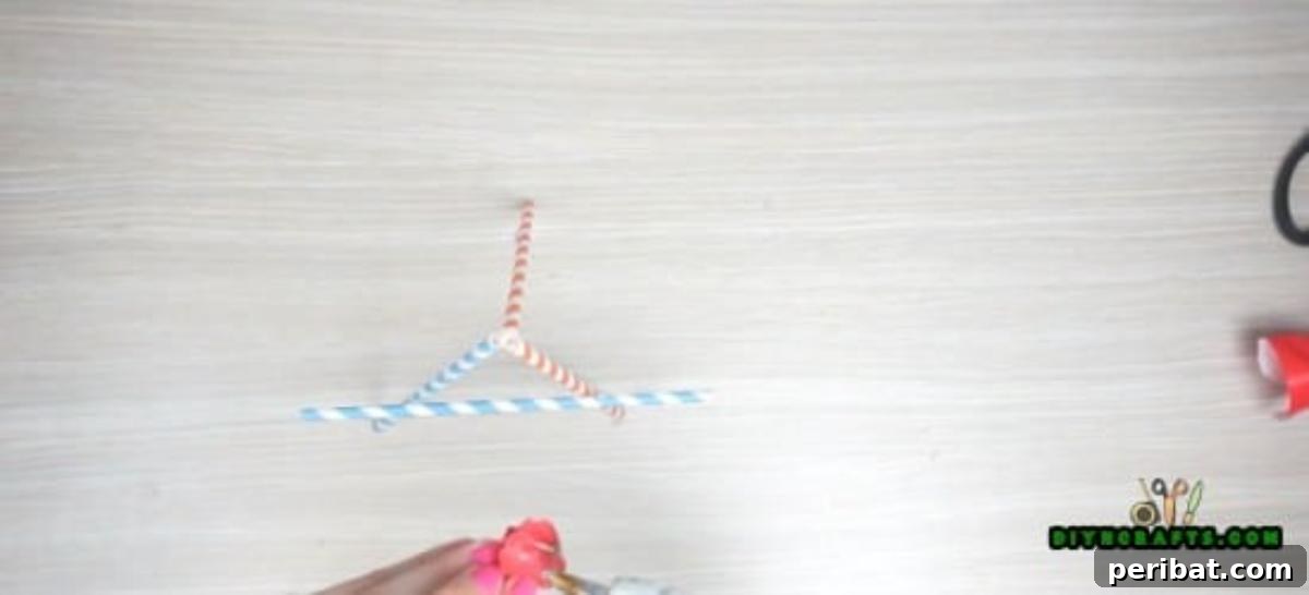 Picture Frame - Step 4: Gluing a horizontal straw across one face of the tripod