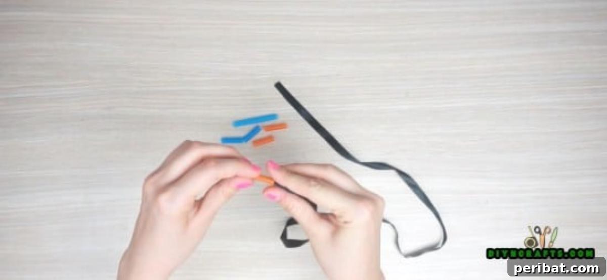 Necklace - Step 2: Threading straw segments onto a ribbon for the initial design