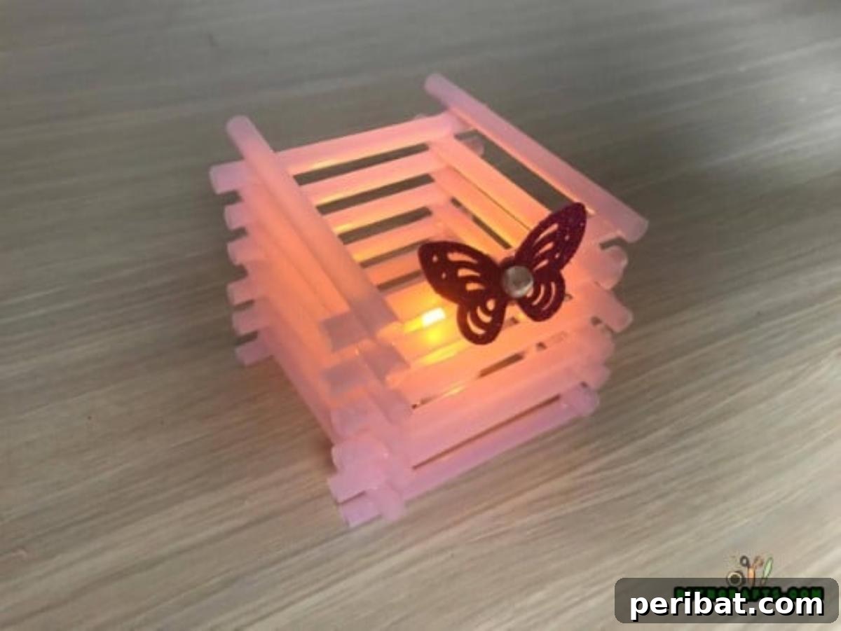Candle Holder - Step 5: Finished straw candle holder with a glowing candle inside