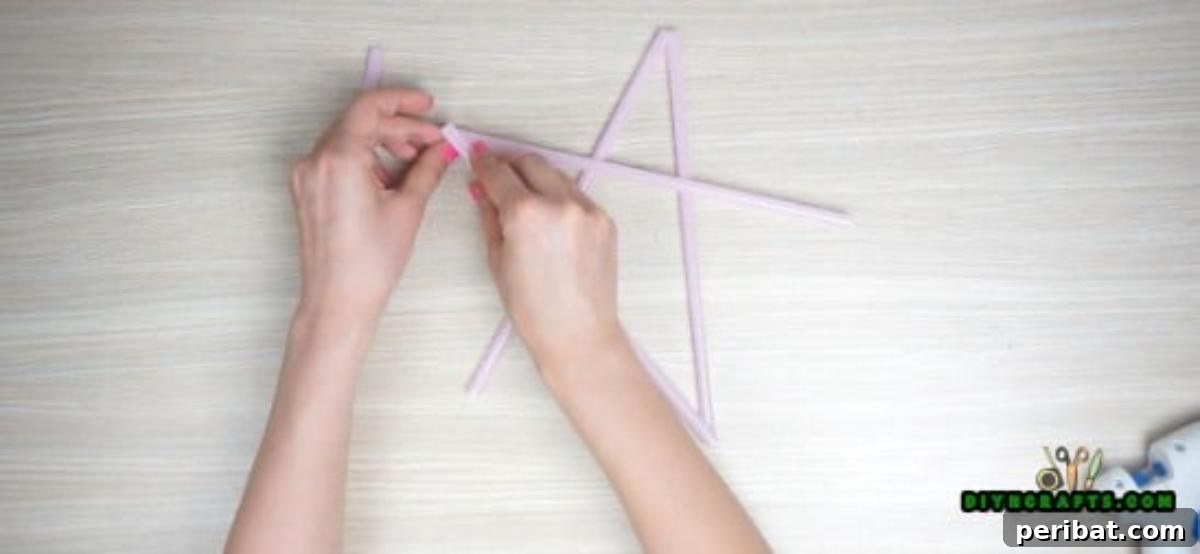 Hanging Stars - Step 1: Continuing to glue additional straws to complete the star outline