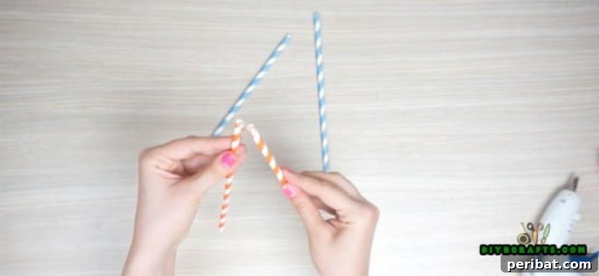 Picture Frame - Step 1: Gluing two straws together to form a teepee shape