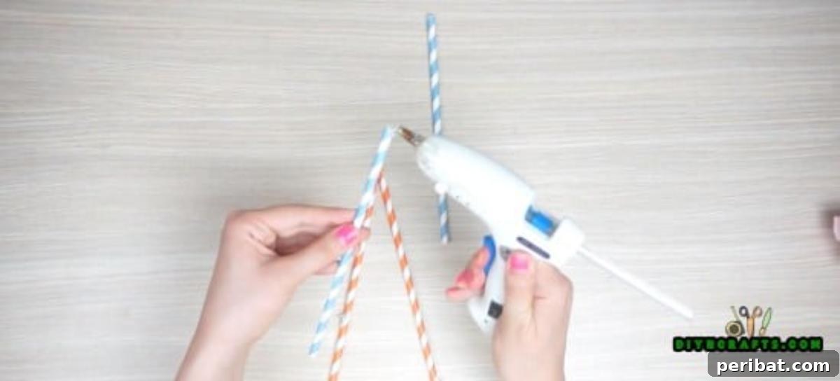 Picture Frame - Step 2: Attaching a third straw downwards from the teepee apex
