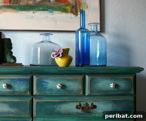 Two custom teal painted furniture pieces with surprising color splotches, demonstrating artistic design from The Turquoise Iris.