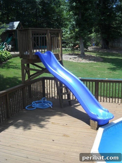 Children enjoying a fun pool slide integrated into a backyard pool