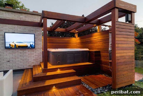 Elegant backyard spa setup with wooden decking and minimalist design