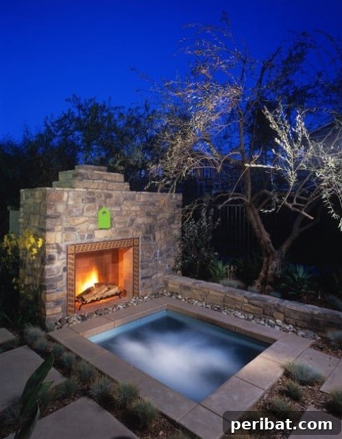 Small in-ground swimming pool complemented by an outdoor stone fireplace