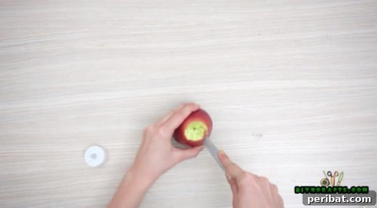 Minutes to Marvelous: 5 Easy Fall DIY Decor Projects 11 Final stage of hollowing the apple, showing the perfectly sized cavity ready to receive the LED votive light.