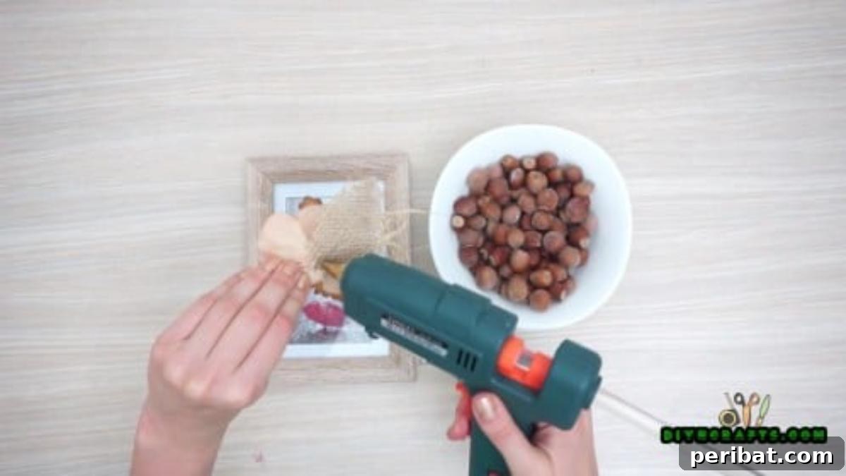 Minutes to Marvelous: 5 Easy Fall DIY Decor Projects 3 Step-by-step: Gluing burlap fabric and fake autumn leaves onto a plain wooden picture frame to begin the fall decor transformation.