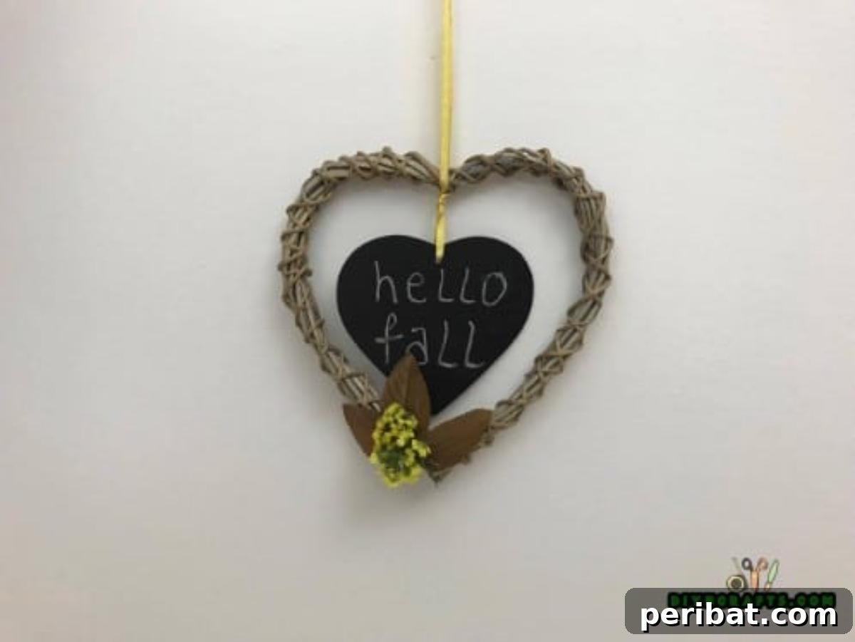 Minutes to Marvelous: 5 Easy Fall DIY Decor Projects 22 The completed 'Hello Fall' wreath, bursting with autumn leaves and flowers, with its welcoming sign, creating a beautiful piece of fall home decor.