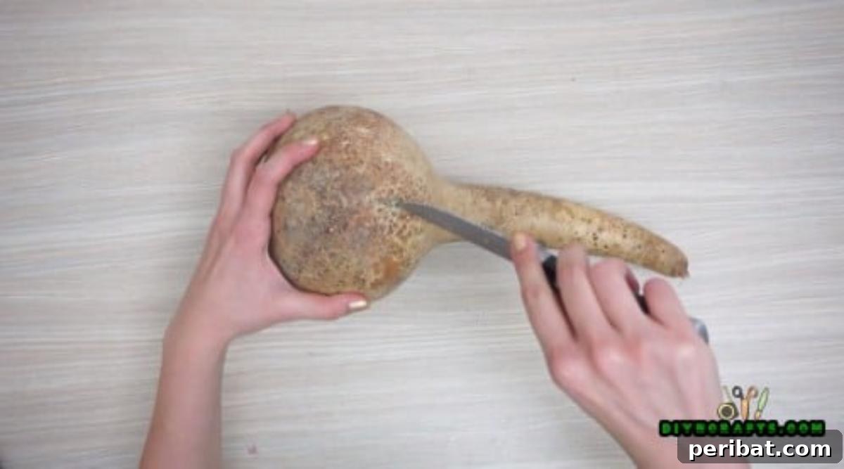 Minutes to Marvelous: 5 Easy Fall DIY Decor Projects 23 Carefully cutting open the top of a decorative gourd with a sharp knife to prepare it for a beautiful fall flower display.