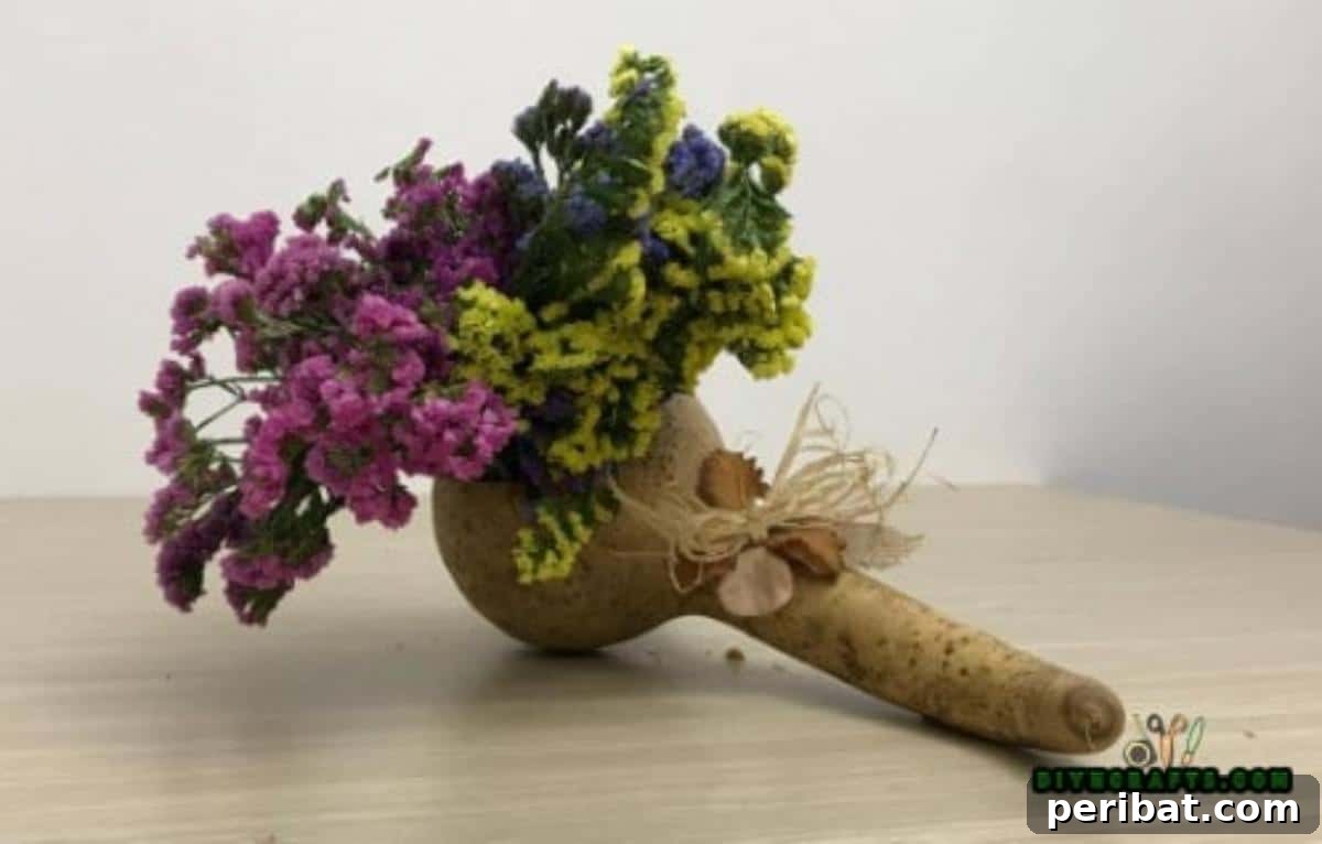 Minutes to Marvelous: 5 Easy Fall DIY Decor Projects 28 The finished gourd flower display, beautifully filled with a vibrant bouquet of autumn flowers, serving as an elegant and natural centerpiece.