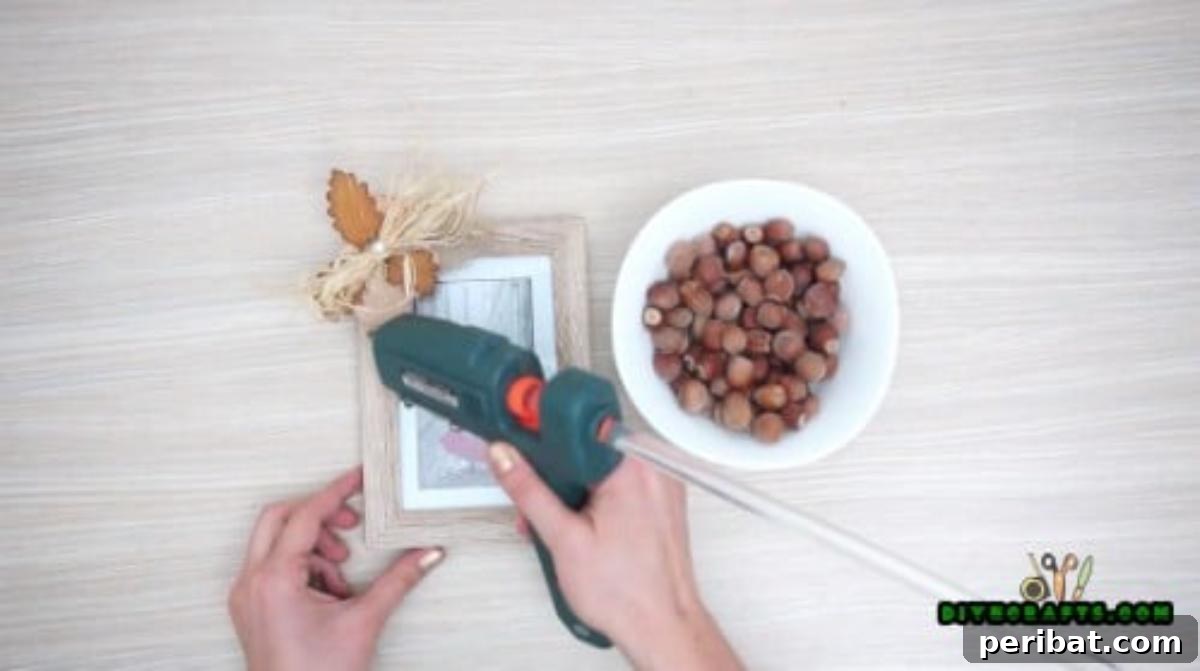 Minutes to Marvelous: 5 Easy Fall DIY Decor Projects 4 Adding decorative straw and a single elegant glass pearl to the corner of the fall-themed picture frame, creating a lovely accent.