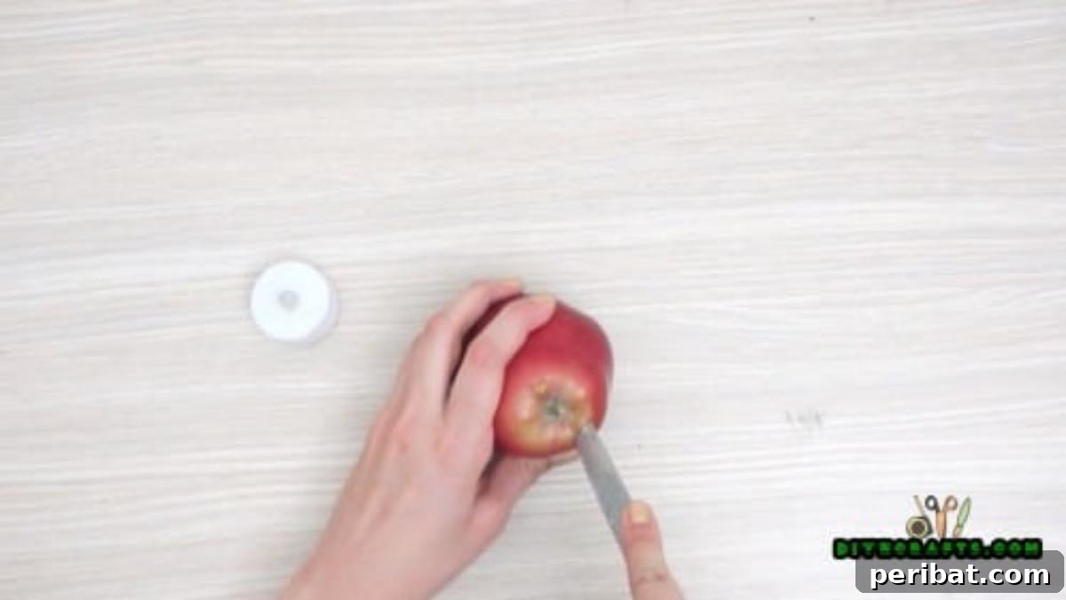 Minutes to Marvelous: 5 Easy Fall DIY Decor Projects 9 Carefully hollowing out the top of a fresh apple with a small knife to create a perfectly sized cavity for the votive candle.