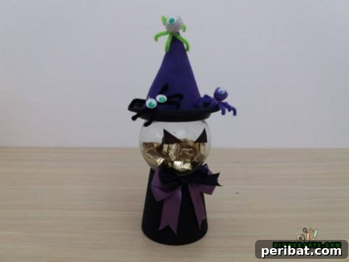 Finished Witch Candy Container, adorned with simple triangle eyes, ready to hold Halloween treats.