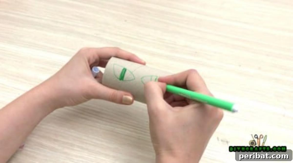 Step 2: Drawing spooky eye shapes onto the toilet paper roll, creating guidelines for cutting out the glowing eyes.