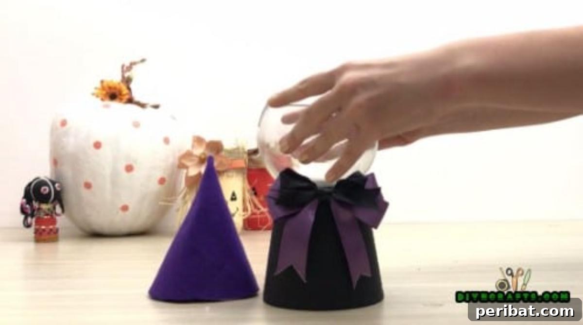 Step 4 continued: Close-up of the bowl being securely glued onto the flower pot, forming the witch's complete base.