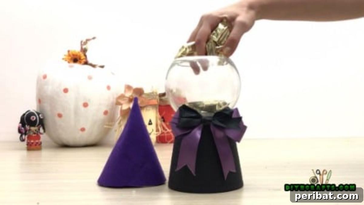 Step 5: Filling the attached bowl with an assortment of Halloween candies, preparing it for display.