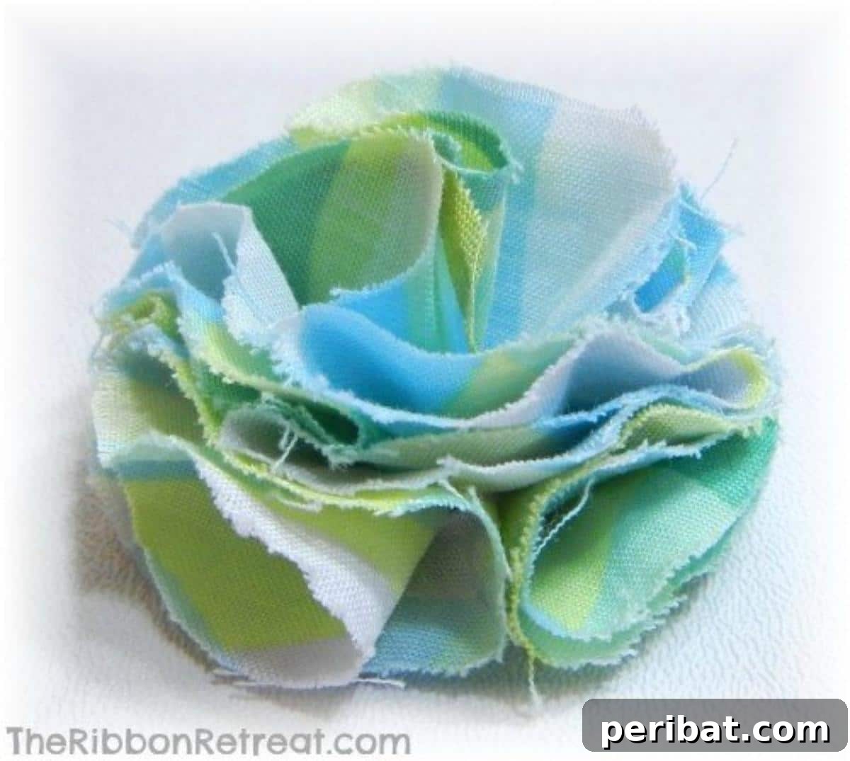 Textured Fabric and Felt Flower Bow, layered with different materials and adorned with a central bead or button.