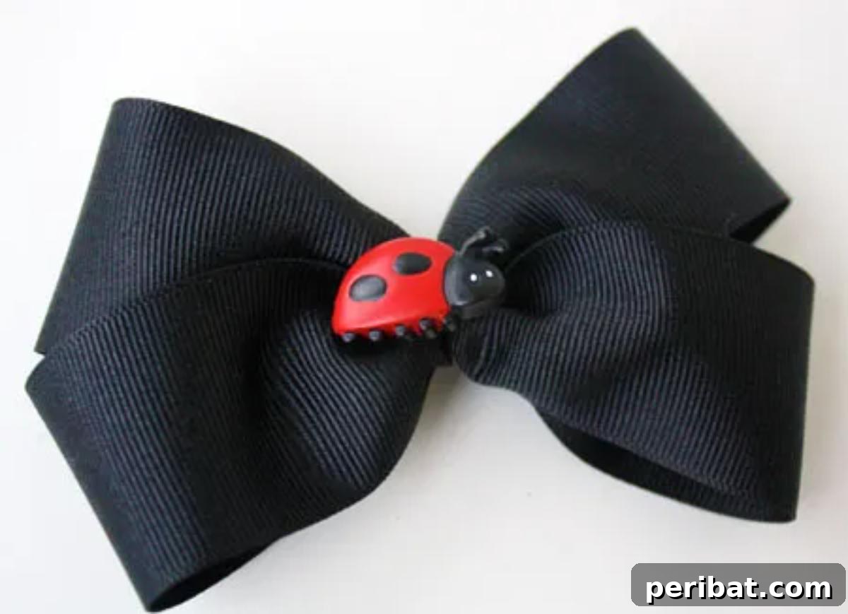 Charming Easy Button Bow, made from a wide ribbon with looped ends meeting in the middle, secured by a decorative button.