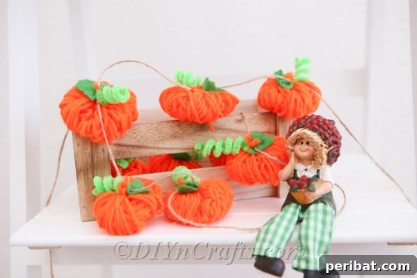 Fall yarn pumpkin garland on a fireplace mantle