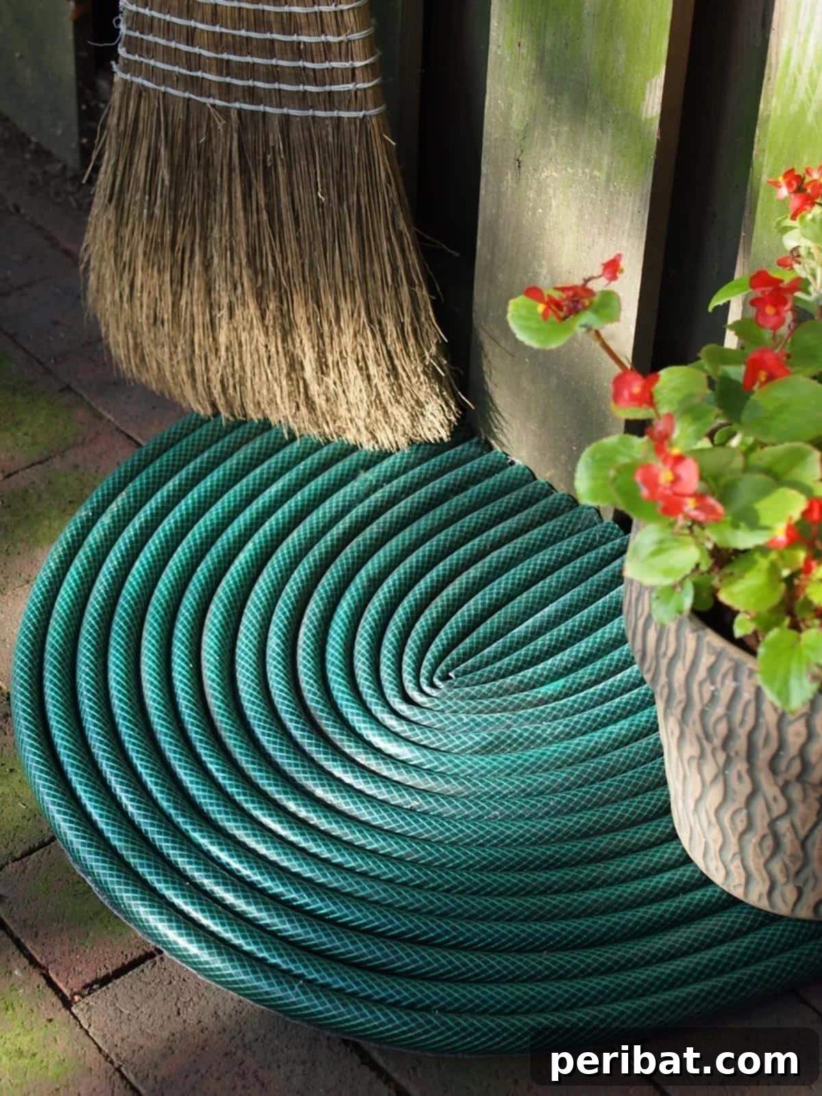 A creative DIY welcome mat made from a repurposed garden hose, coiled into a functional and unique design.