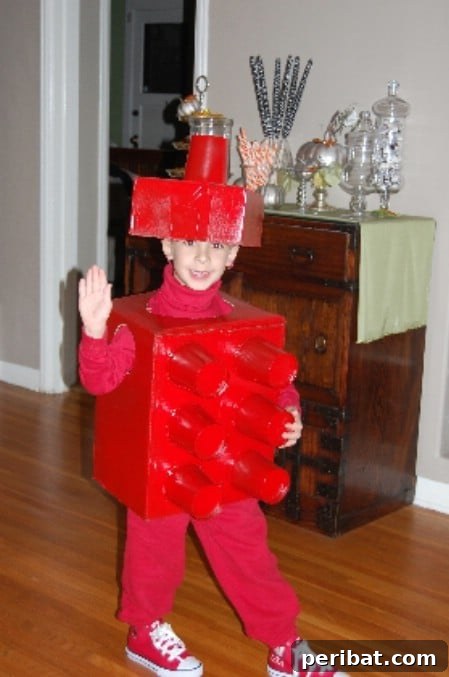 75 Effortless DIY Halloween Costumes That Kids Adore 20 A child transformed into a 'Lego Man' for Halloween, a creative DIY costume made from cardboard