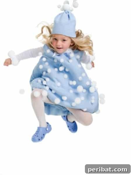 75 Effortless DIY Halloween Costumes That Kids Adore 29 A child transformed into a 'Snowball' for Halloween, wearing a light blue sweatshirt adorned with white felt and Styrofoam balls