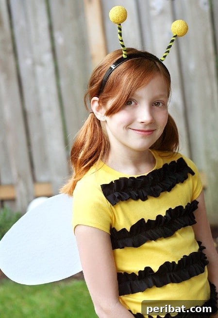 75 Effortless DIY Halloween Costumes That Kids Adore 38 A child in an 'Easy Bumble Bee' costume, featuring a yellow shirt with black ruffles, wings, and antennae, a quick DIY idea