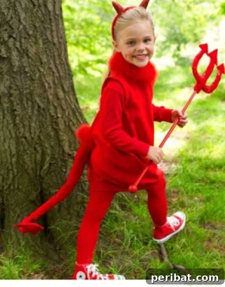 75 Effortless DIY Halloween Costumes That Kids Adore 40 A child in a classic 'Little Devil' costume for Halloween, featuring an all-red outfit, horns, and a pitchfork