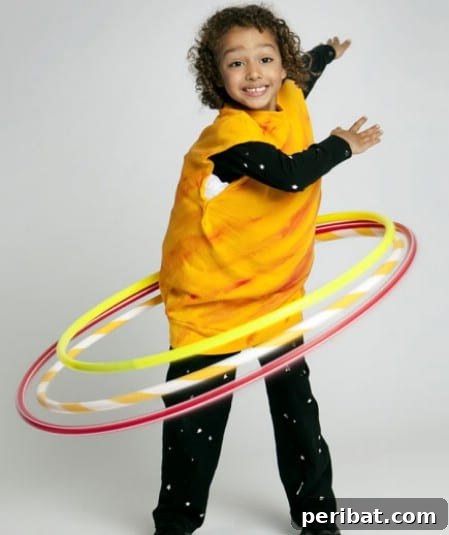 75 Effortless DIY Halloween Costumes That Kids Adore 41 A child in a creative 'Saturn' costume for Halloween, featuring black sweats, star stickers, painted bands, and hula-hoop rings