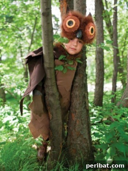 75 Effortless DIY Halloween Costumes That Kids Adore 48 A child in an adorable 'Owl' costume for Halloween, featuring a feathered body, brown pants, and a wise mask, a charming DIY idea