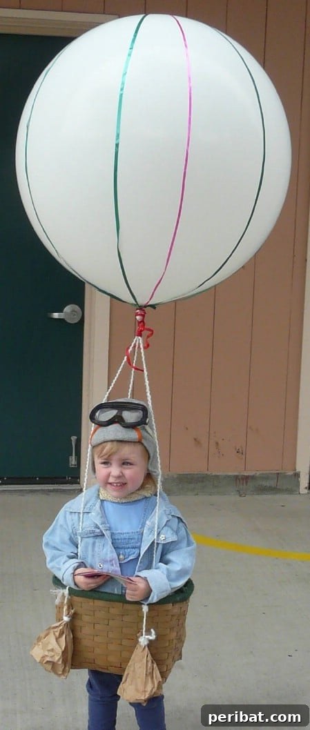 75 Effortless DIY Halloween Costumes That Kids Adore 52 A child in a charming 'Hot Air Balloon' costume for Halloween, featuring a large basket, yarn, and a helium balloon, a unique DIY idea